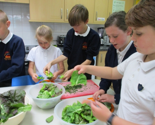 Pupils-preparing-a-salad-as-part-of-Water-Aid